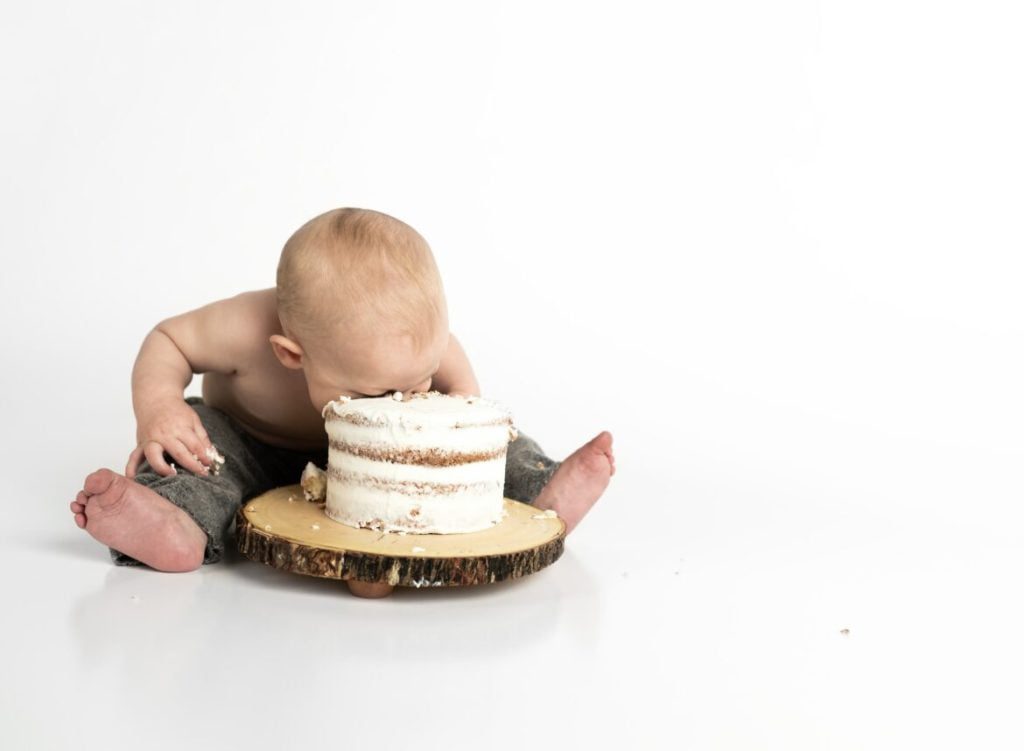 baby boy face buried in cake