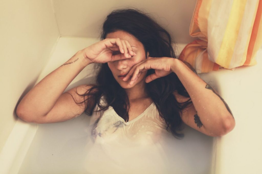 woman in filled tub thinking about life