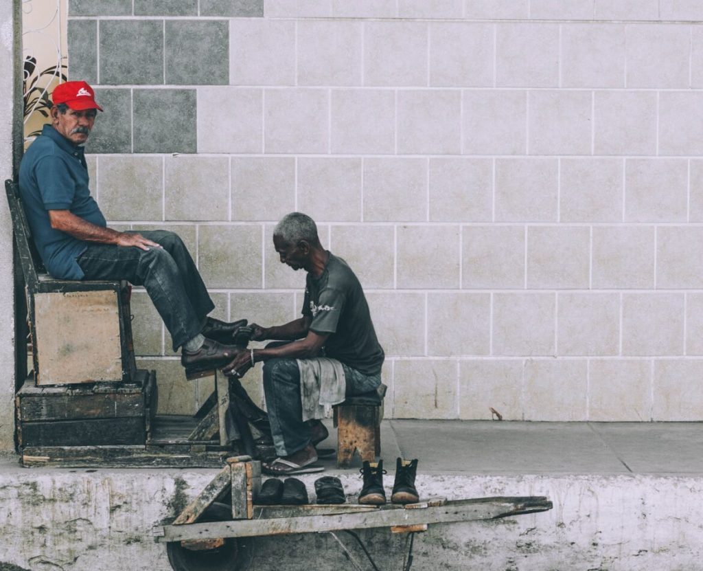 man polishing shoe shea butter uses